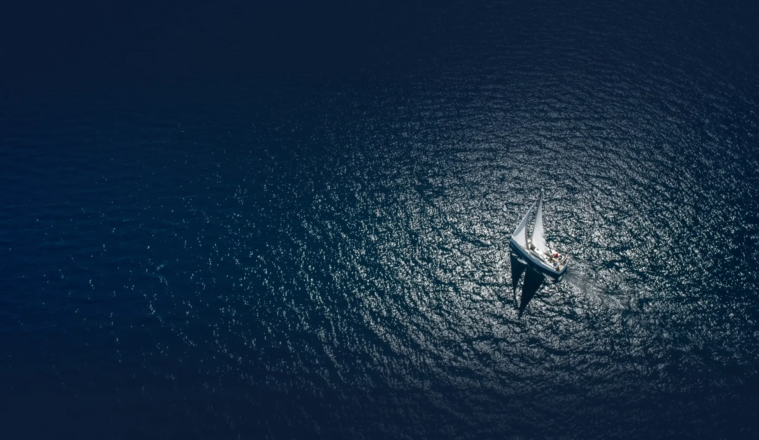 overhead view of sailboat in open water