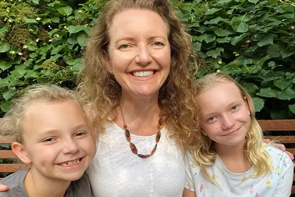 sally hughes and her children smile outside