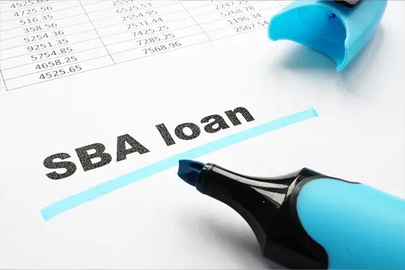 the words "sba loan" highlighted on a paper