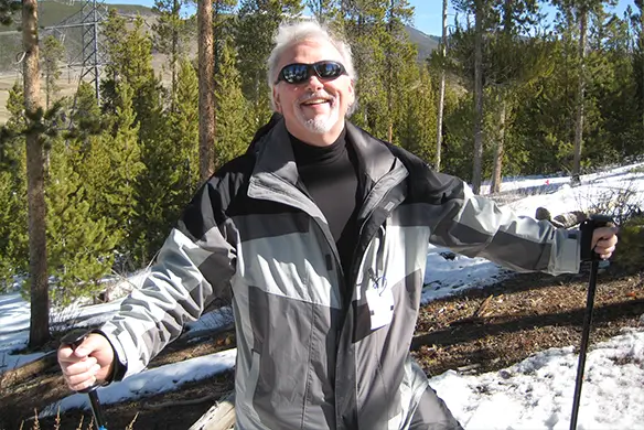 chuck harvey smiles while outdoors
