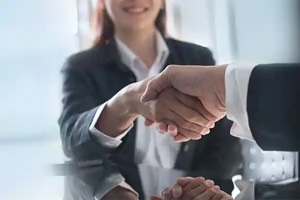 two M&A professionals shaking hands